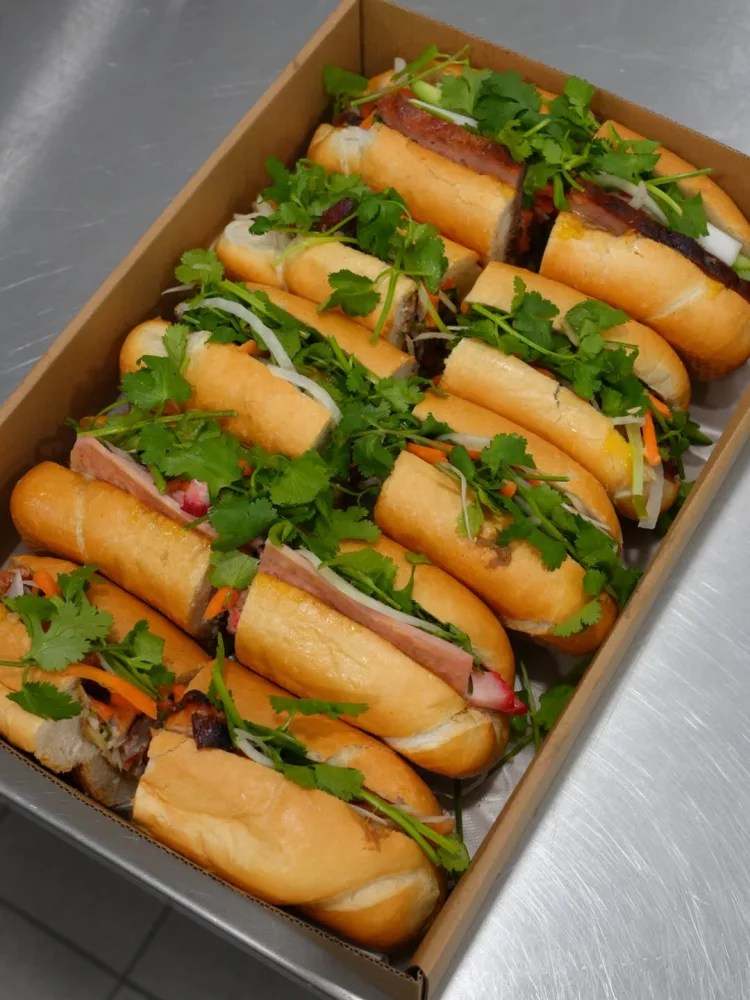 A box of bánh mì filled and ready to share