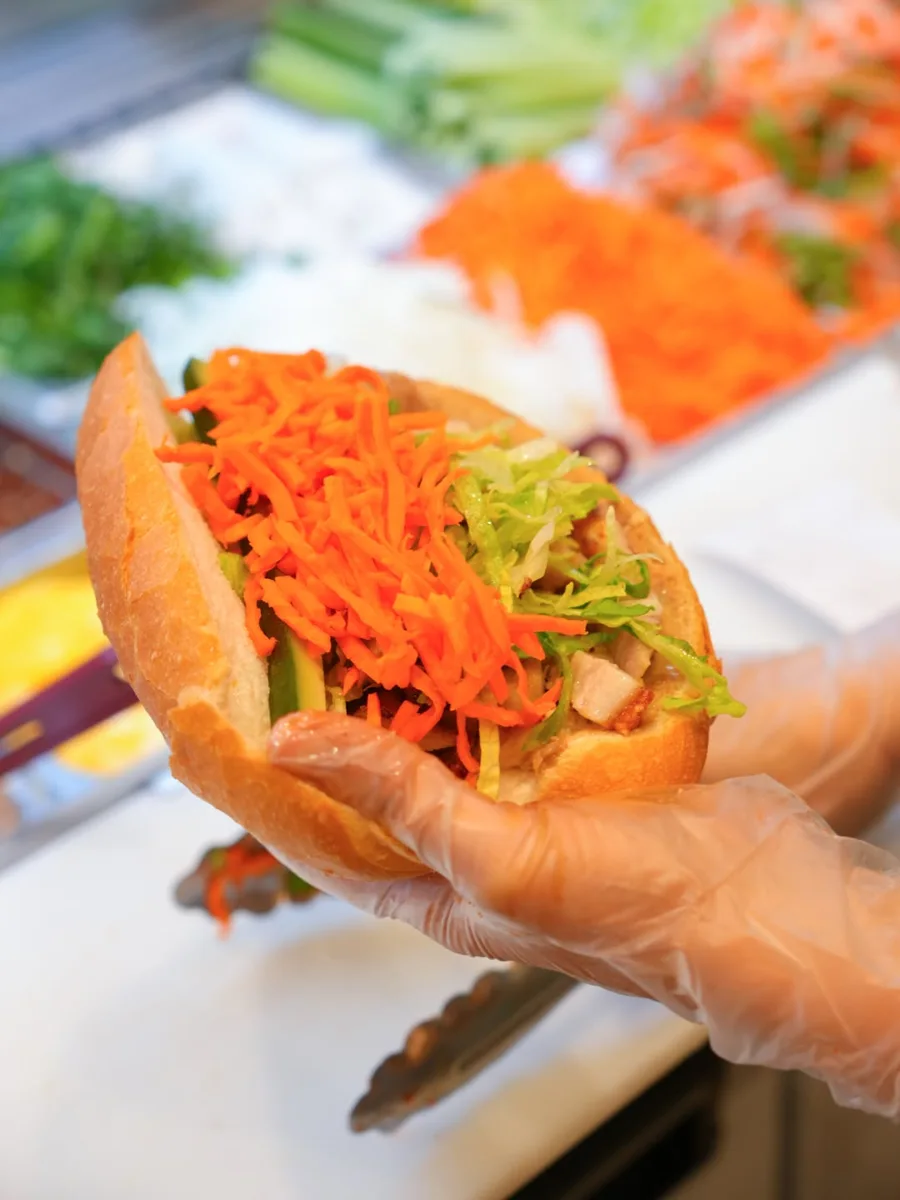 A freshly filled bánh mì being prepared at Banh Mi & Co