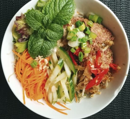 Lemongrass beef bowl with vegetables and fresh herbs