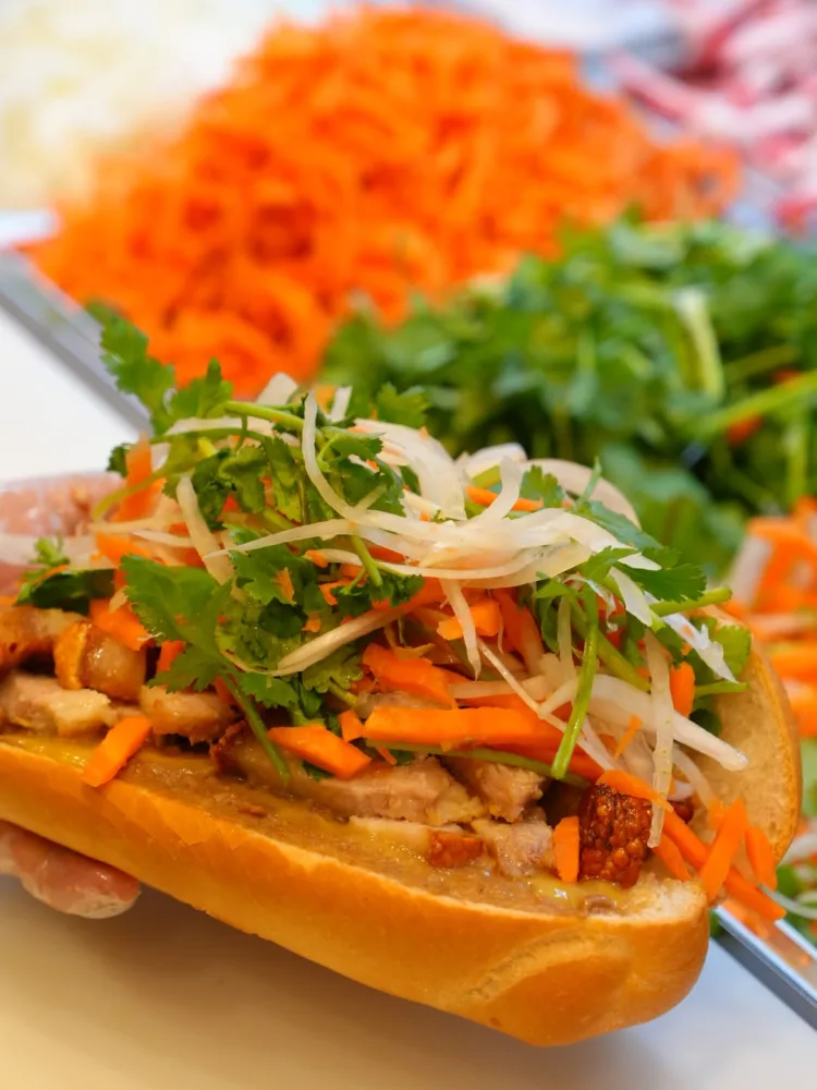 Bánh mì loaded with meat, pickled carrot, coriander and chilli